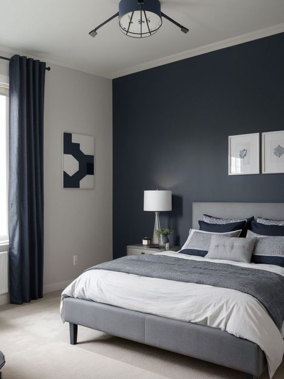 Dormitorio con paredes pintadas azul oscuro y gris